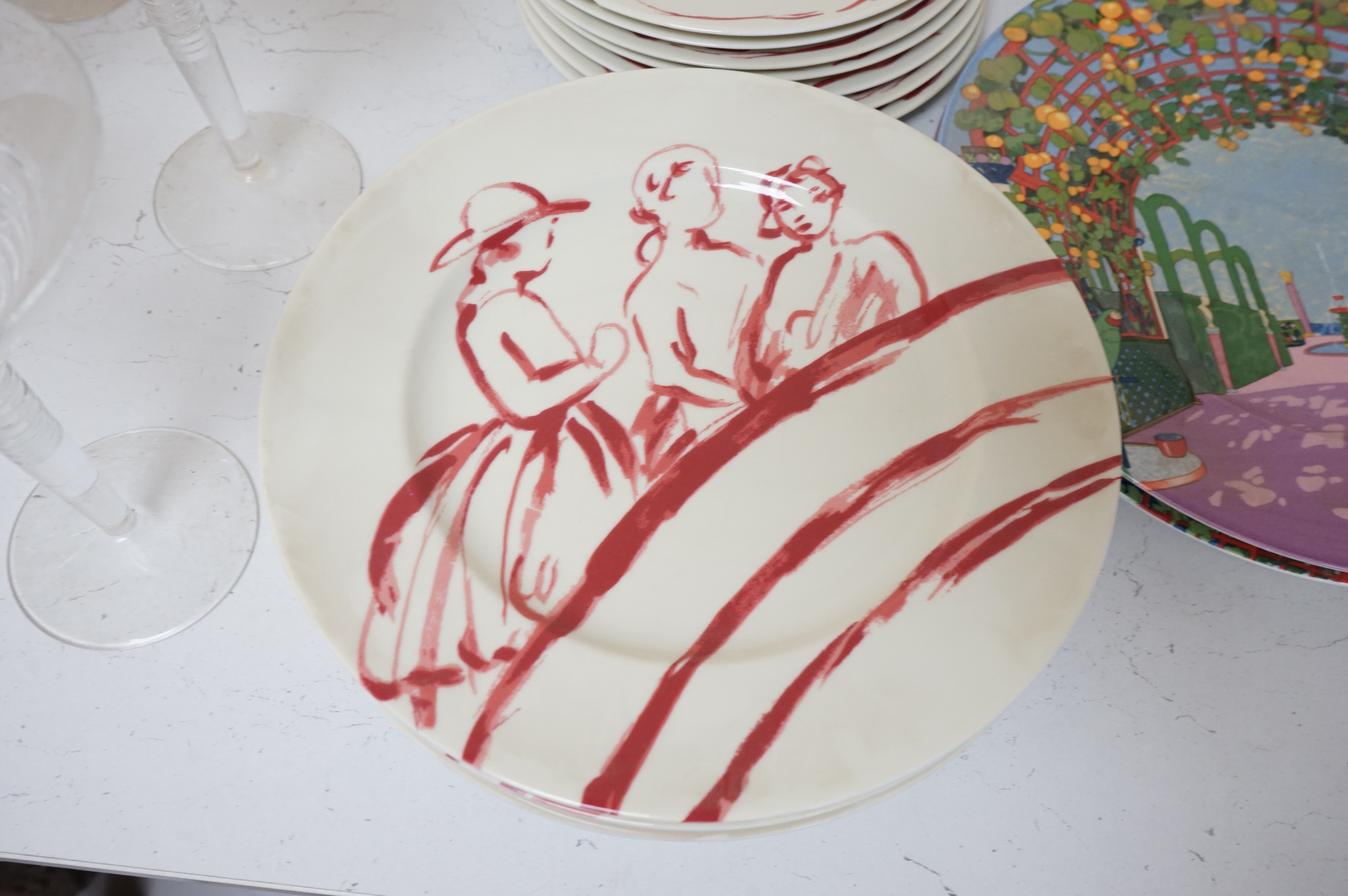 A Pierre Frey ‘Gonesse’ Limoges part dinner service, two Villeroy and Boch ‘Jardins Francais’ dinner plates, with a collection of Riedel wine glasses and mixed Salviati champagne glasses. Villeroy and Boch plates 30.5cm